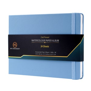 May include: A blue watercolor paper album with a black label that reads "Cold Pressed Watercolor Paper Album 24 Sheets". The label also includes the dimensions of the paper: 8.3" x 5.8".