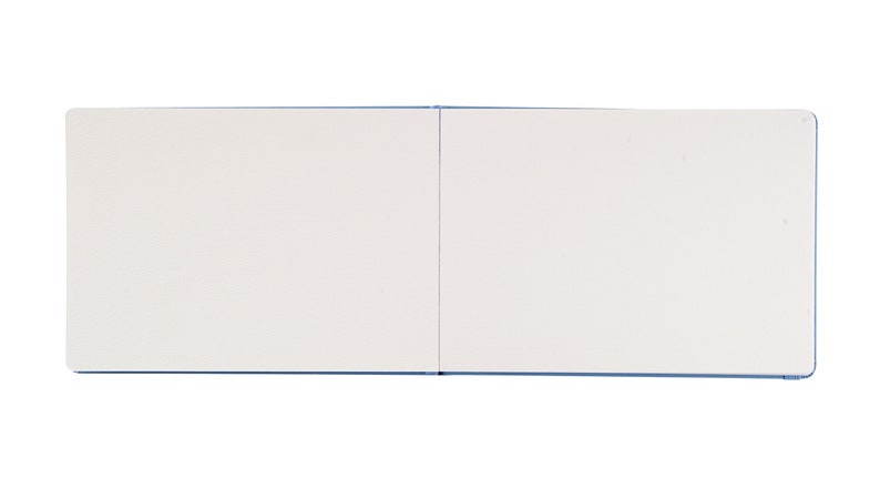 May include: A blank, white sketchbook with a blue cover. The sketchbook is closed and lying flat.