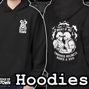 May include: Black hoodie with a front pocket and hood. The front features a white graphic and the text "EDGE OF TOWN". The back displays a design with two helmeted figures and the text "WHAT IF WE TOUCHED HELMETS UNDER A 500".