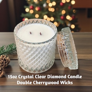 May include: A clear, diamond-patterned glass candle jar with a white wax fill and two wicks. The lid is off to the side. The text on the bottom reads "15oz Crystal Clear Diamond Candle Double Cherrywood Wicks."