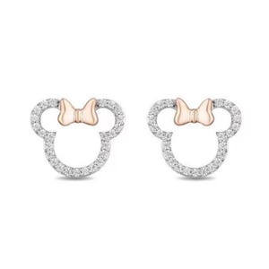 May include: A pair of stud earrings in a Minnie Mouse design. The earrings have a silver outline, set with small, clear stones. A rose gold bow sits at the top of each earring, completing the iconic silhouette.