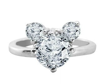 May include: A silver ring with three clear cubic zirconia stones set in a Mickey Mouse shape.