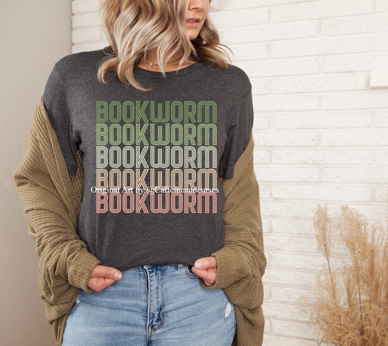 May include: A dark gray t-shirt with the word "BOOKWORM" repeated five times in a retro style font. The text is in shades of green, yellow, and pink.