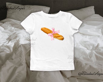 Baguette rose ruban noeud coquette T-shirt bébé | T-shirt bébé graphique de l'an 2000, t-shirt bébé des années 90, t-shirt bébé tendance, t-shirt pâtissier, t-shirt fille cool