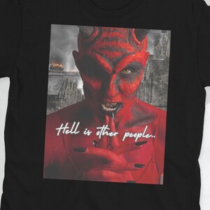 May include: Black t-shirt with a graphic of a red devil with horns and the text "Hell is other people."
