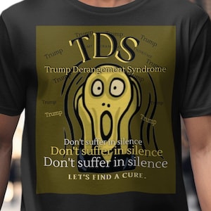 May include: A black t-shirt with a yellow graphic of the famous painting "The Scream" by Edvard Munch. The graphic includes the text "TDS" which stands for "Trump Derangement Syndrome" and the phrase "Don't suffer in silence. Let's find a cure."