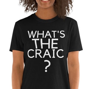 May include: A black t-shirt with white text that reads "What's the craic?"