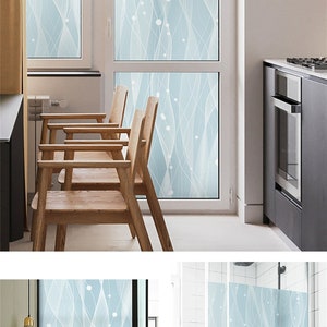 May include: A frosted window film with a light blue background and a white abstract design. The design features wavy lines and small white circles. The film is shown applied to a window in a kitchen and a bathroom. The text "Style-10" is visible in the image.