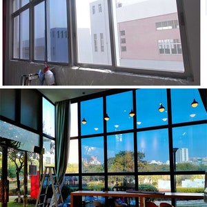 May include: A window film with a navy blue and silver tint. The film is applied to a window and shows the outside view through the film. The text on the image reads "Style-10 Navy Blue with Silver", "Material: Premium PET", "Feature: One way mirror tint window film", "Thickness: 2mil", "Application: Building, hotel, warehouse, office, studio, home".