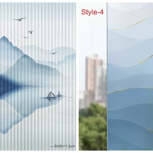 May include: Two window film designs. The first design features a blue and white watercolor mountain scene with a boat on a lake. The second design features a blue and gold watercolor wave pattern. Both designs are 1.5 inches wide.