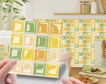 May include: A set of peel and stick tile stickers featuring a yellow, green, and beige geometric pattern. The stickers are designed to look like individual tiles and can be used to update the look of a kitchen or bathroom.