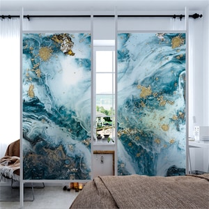 May include: Two frosted glass panels featuring a blue and white abstract marble design with gold accents. The panels are installed in a room with a bed and a chair.