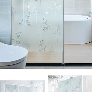 May include: A frosted glass window film with a delicate floral pattern in shades of gray and white. The film is shown installed in a bathroom, with a bathtub and toilet visible. The text "Style-11" is displayed in the top right corner of the image.
