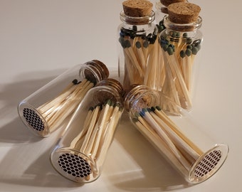 Glass Bottle with 20 matches and honeycomb striker on bottom