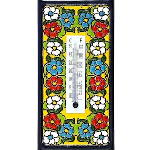 May include: A decorative thermometer with a floral design. The thermometer features a yellow background with red, blue, and white flowers. The temperature scale is in Fahrenheit and Celsius.