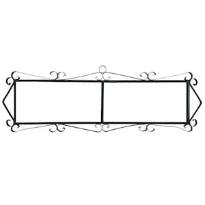 May include: Black metal sign with two rectangular blank spaces for text. The sign has decorative scrollwork at the corners and along the top and bottom edges. The overall shape is rectangular with pointed ends.