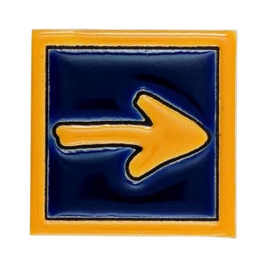 May include: Square ceramic tile with a glossy finish. The tile features a navy blue center with a bright yellow arrow pointing right, outlined in black. The tile is framed by a yellow border.