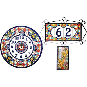 May include: A collection of colorful ceramic home decor items. Includes a round clock with a blue border, a house number plaque with the number 62, and a thermometer. All items feature floral and geometric designs.