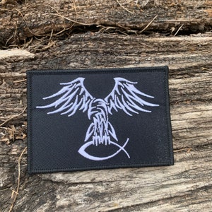 May include: White embroidered patch on a black background featuring an eagle with outstretched wings and a stylized fish symbol below.