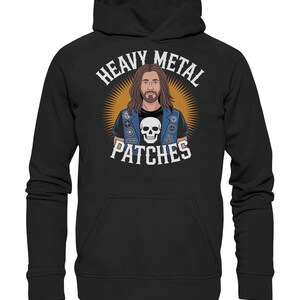 May include: Black hoodie with a graphic of a person with long hair and a beard wearing a denim vest with patches and a skull. The text "HEAVY METAL PATCHES" is above the graphic in white.