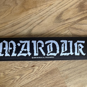 May include: Black patch with white lettering that reads "MARDUK U.L.T.R.A.Z.A.M.A.T.A.Z" and "MARDUK" in a large, stylized font.