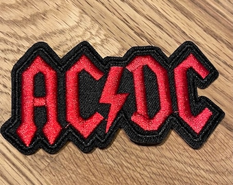 Toppa Ricamo AC/DC Plug Me In - In Tessuto Per Giubbotti E Zaini, Design Licenziato