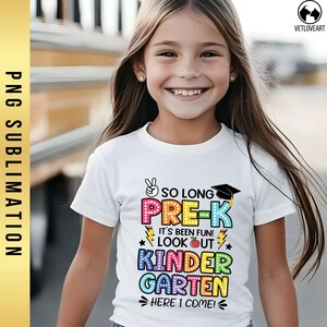 May include: A white t-shirt with a colorful graphic that says "So Long Pre-K It's Been Fun! Look Out Kindergarten Here I Come!"