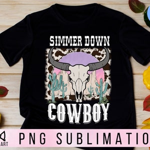 May include: Black t-shirt with a white graphic design of a cow skull with cacti and the text "Summer Down Cowboy".