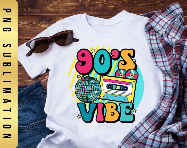 May include: White t-shirt with a colorful graphic design featuring the text "90's Vibe" with a disco ball, cassette tape, and stars.