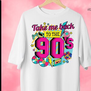 May include: White t-shirt with a graphic design featuring the text "Take me back to the 90's" in pink and blue lettering. The design includes retro 90's icons like a cassette tape, a game cartridge, a game controller, a Tamagotchi, and a Rubik's Cube.