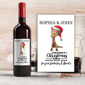 May include: A white wine bottle label featuring a cartoon giraffe wearing a Santa hat. The label reads "Sophia & John" and "Merry Christmas and Happy New Year" with a message from Kimberley & David.