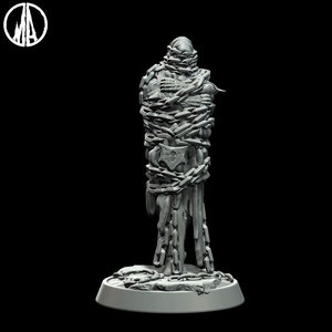 May include: A gray, 3D printed miniature figure of a humanoid figure bound in chains. The figure is standing on a circular base.