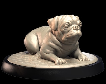 May include: A light gray pug dog sculpture, lying down with its front paws extended. The pug is on a round, textured base with a black rim. The sculpture has detailed facial features and wrinkles, set against a black background.