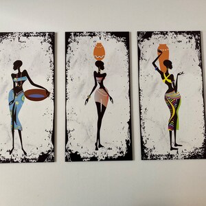May include: Three black and white silhouette paintings of women in colorful clothing carrying various items on their heads. The paintings have a distressed white background with black borders.