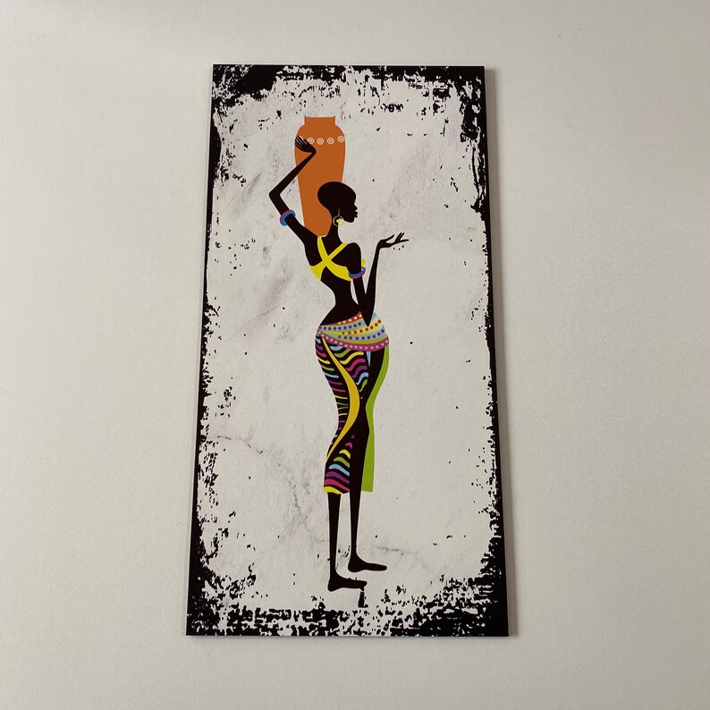 May include: A black and white silhouette of a woman carrying a brown pot on her head. She is wearing a colorful patterned skirt and a yellow necklace. The background is a white and black distressed texture.
