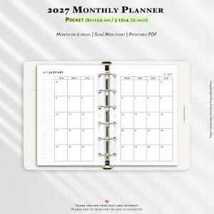 May include: A 2027 monthly planner in a pocket size of 3.19 by 4.72 inches. The open planner features a six-ring silver metal binder mechanism holding white pages with a black grid calendar layout for January, showing days from Sunday to Saturday.