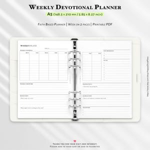 May include: A white A5 weekly devotional planner with a silver binder. The planner includes sections for weekly plans, scriptures, reflection, prayer focus, faith action, and gratitude. The planner measures 14.85 x 21.0 cm.
