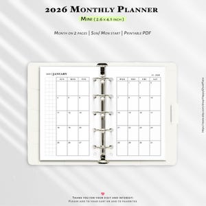 May include: A white mini 2026 monthly planner, measuring 6.6 x 10.4 cm, with a ring binder. The planner displays a January calendar with a grid layout. Text includes "Month on 2 Pages" and "Printable PDF".