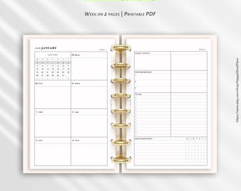 May include: A 2026 weekly planner in a half-letter 5.5 x 8.5 inch format. The open planner features a gold disc-bound spine, a January calendar view, daily scheduling blocks, goal tracking, top priorities, to-do lists, and daily routines.
