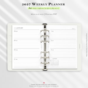 May include: A 2027 weekly planner A6 size measuring 105 by 148 mm. The open ring-bound planner displays a week on two pages with lined sections for each day, a January calendar, and the text 2027 Weekly Planner, Week on 2 Pages, Printable PDF.