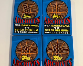 May include: Four Topps Archives NBA Basketball trading card packs. Each pack features a blue background with a basketball graphic and the text "Topps Archives NBA Basketball 14 Super Premium Picture Cards."