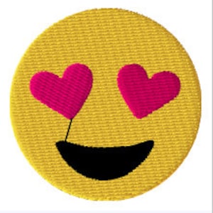 May include: Yellow smiley face emoji with pink hearts for eyes and a black smile.