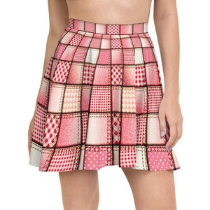 May include: A red and white plaid skater skirt with a patchwork design. The skirt has a high waist and a flared silhouette.