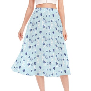 May include: A light blue midi skirt with a white and blue blueberry print.