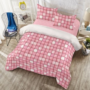 May include: Pink and white checked bedding set with a duvet cover, two pillowcases, and a decorative throw pillow. The bedding features a patchwork design with squares of different sizes.