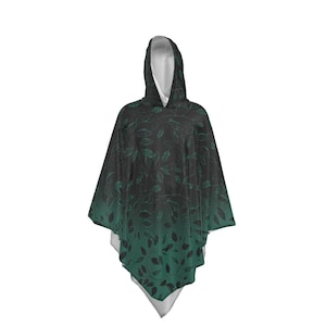 May include: A hooded poncho with a black and green ombre design featuring a leaf pattern.