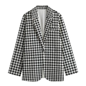 May include: A black and white houndstooth blazer with a single-button closure. The jacket features a classic notched lapel and long sleeves. The interior lining is white. This tailored blazer is suitable for various occasions.