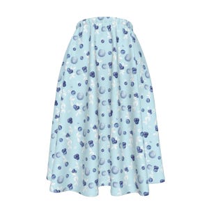 May include: A light blue skirt with a white and blue blueberry print.