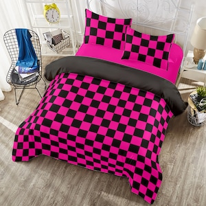 May include: A pink and black checkered bedding set with a black and pink checkered duvet cover, two pillowcases, and a black and pink checkered throw pillow.
