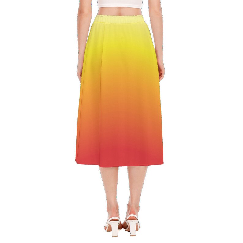 May include: A yellow to red ombre midi skirt with an elastic waistband.